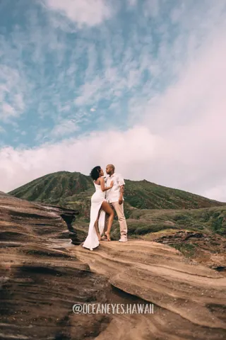 Couple on a volcanic crater ridge in Hawaii