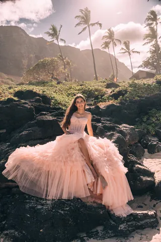 Woman in a pink tulle gown on lava rocks in Hawaii