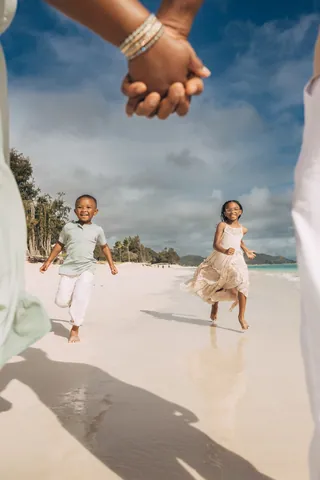 Kids running on the beach in Hawaii