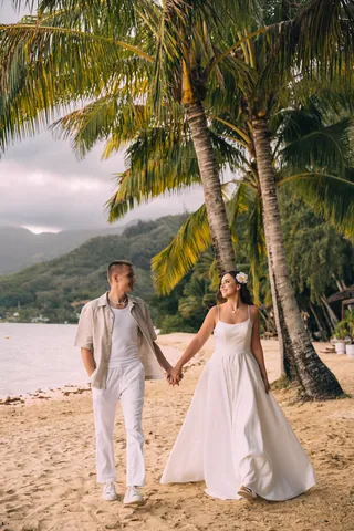 Bride and groom on a palm beach in Hawaii